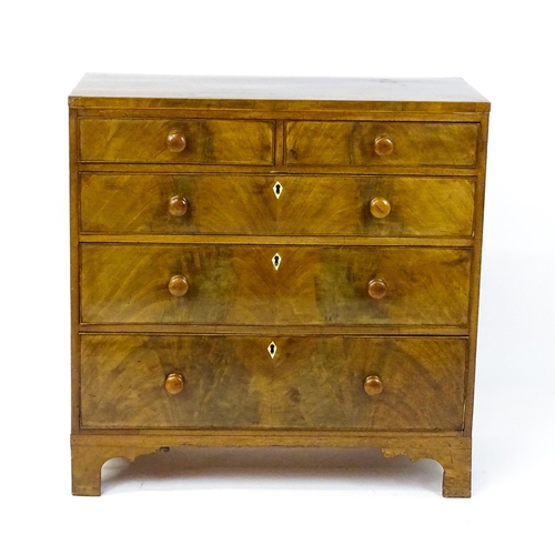 1740 - A Georgian mahogany chest of drawers with two short drawers over three long drawers with diamond sha... 