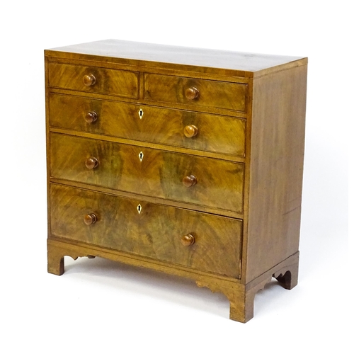 1740 - A Georgian mahogany chest of drawers with two short drawers over three long drawers with diamond sha... 