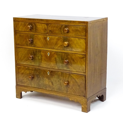 1740 - A Georgian mahogany chest of drawers with two short drawers over three long drawers with diamond sha... 