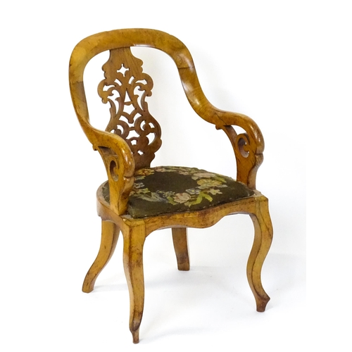 1741 - A late 19thC walnut child's chair with a bowed backrest above a pierced back splat and raised on cab... 