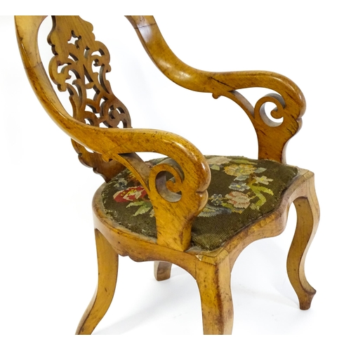 1741 - A late 19thC walnut child's chair with a bowed backrest above a pierced back splat and raised on cab... 