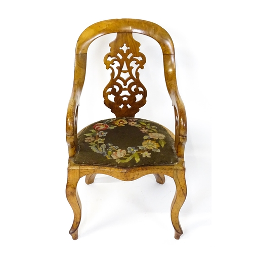 1741 - A late 19thC walnut child's chair with a bowed backrest above a pierced back splat and raised on cab... 