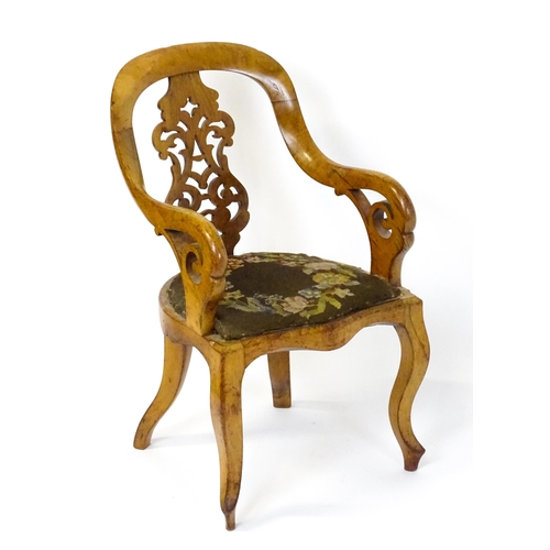 1741 - A late 19thC walnut child's chair with a bowed backrest above a pierced back splat and raised on cab... 