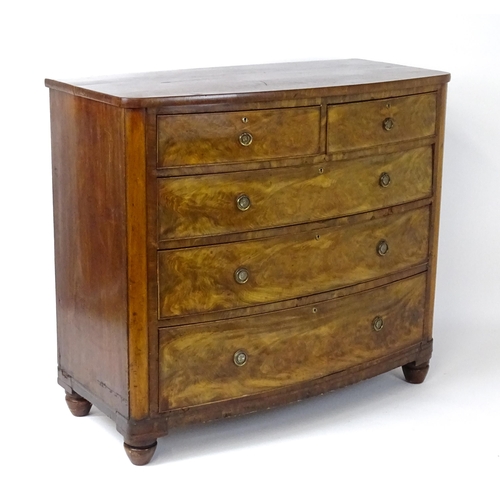 1743 - A 19thC mahogany bow fronted chest of drawers comprising two short over three long graduated drawers... 