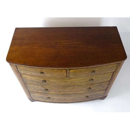 1743 - A 19thC mahogany bow fronted chest of drawers comprising two short over three long graduated drawers... 