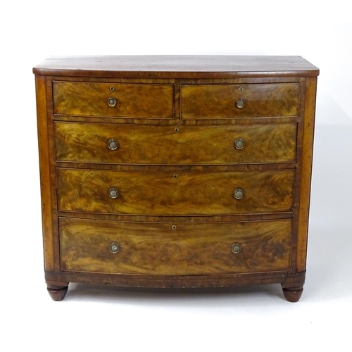 1743 - A 19thC mahogany bow fronted chest of drawers comprising two short over three long graduated drawers... 