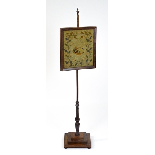 1750 - A late 19thC mahogany pole screen with a needlework panel above a turned stem and a stepped base. 53... 