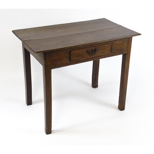 1754 - A Georgian oak side table with a single frieze drawer above a two plank top, single frieze drawer an... 