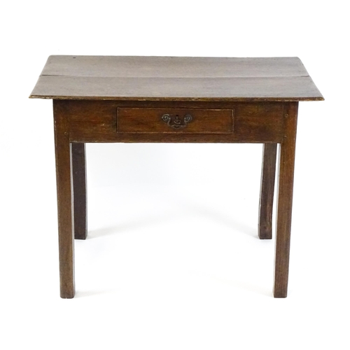 1754 - A Georgian oak side table with a single frieze drawer above a two plank top, single frieze drawer an... 