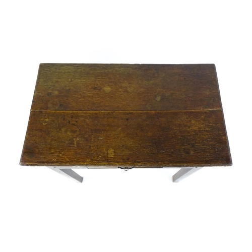 1754 - A Georgian oak side table with a single frieze drawer above a two plank top, single frieze drawer an... 