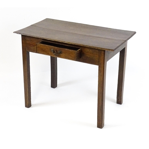 1754 - A Georgian oak side table with a single frieze drawer above a two plank top, single frieze drawer an... 