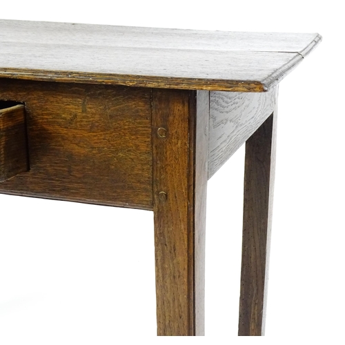 1754 - A Georgian oak side table with a single frieze drawer above a two plank top, single frieze drawer an... 