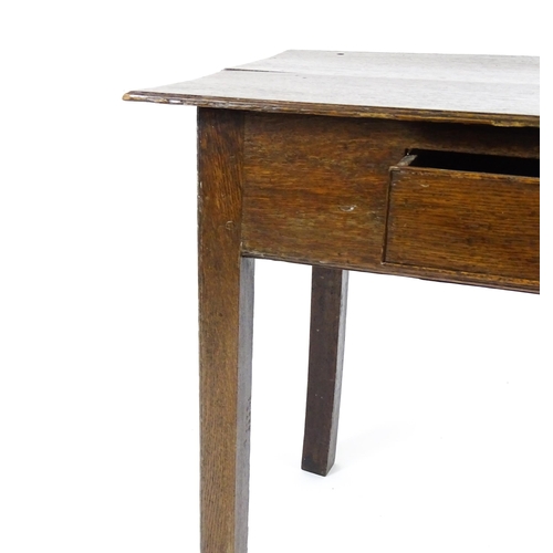 1754 - A Georgian oak side table with a single frieze drawer above a two plank top, single frieze drawer an... 