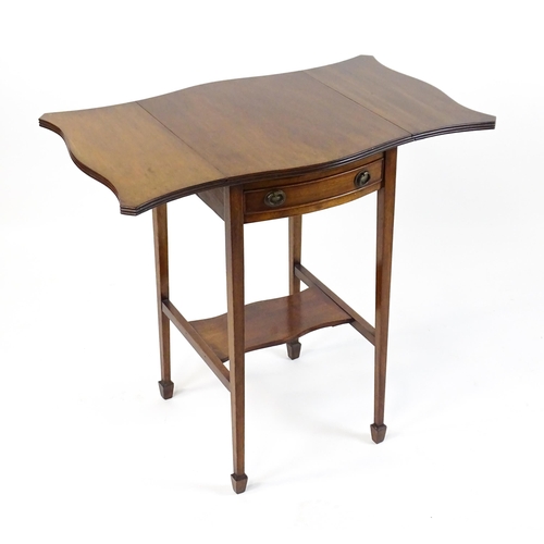 1757 - An early 20thC mahogany occasional table with two drop leaves flanking a single frieze drawer raised... 