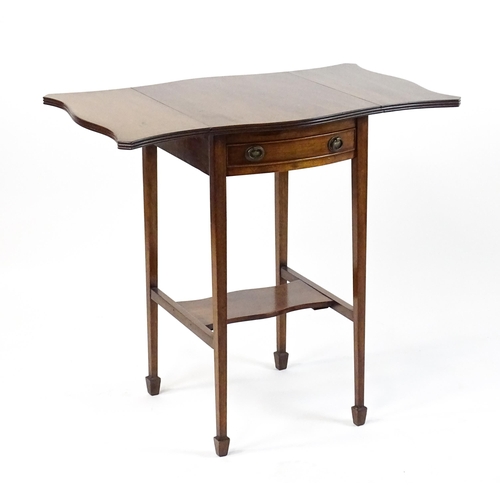 1757 - An early 20thC mahogany occasional table with two drop leaves flanking a single frieze drawer raised... 