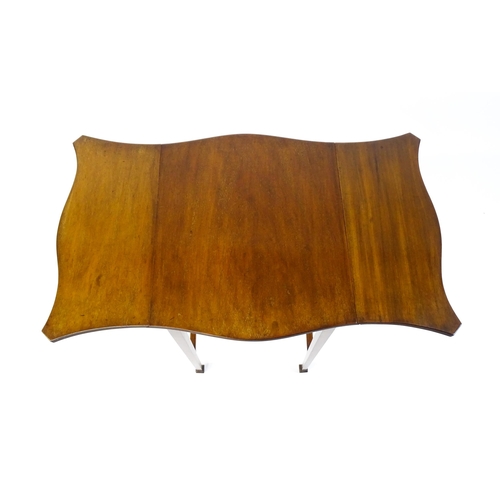 1757 - An early 20thC mahogany occasional table with two drop leaves flanking a single frieze drawer raised... 