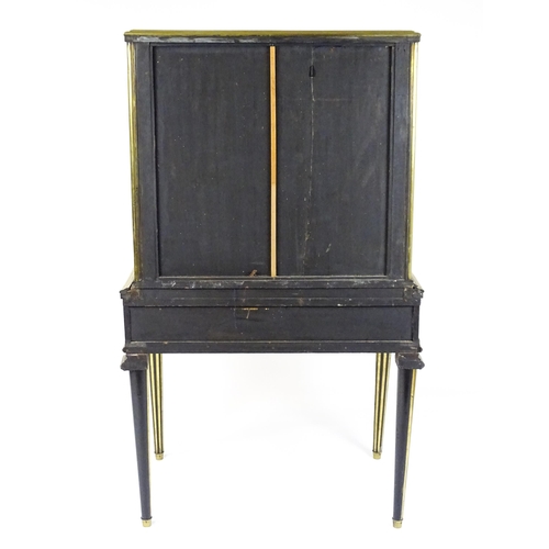 1758 - A 19hC vitrine with two glass doors lined with brass mouldings above a base with a hinged lid and ra... 