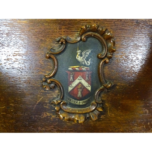 1760 - A late 19thC / early 20thC oak Glastonbury chair with a painted armorial to the centre of the backre... 