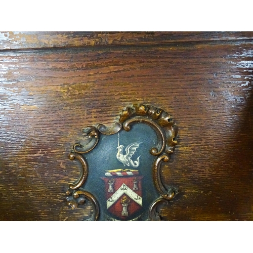 1760 - A late 19thC / early 20thC oak Glastonbury chair with a painted armorial to the centre of the backre... 