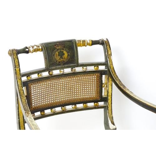 1761 - A Regency open armchair with a green painted and gilt finish. The chair having a painted armorial to... 