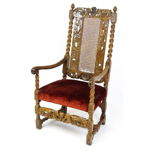 1793 - A 19thC Carloean style armchair with a carved cresting rail above barley twist supports and a caned ... 