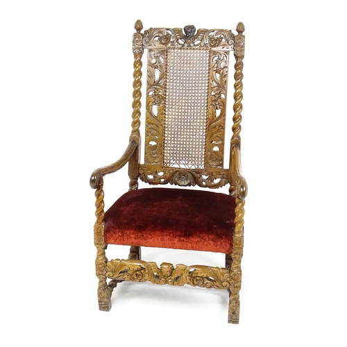 1793 - A 19thC Carloean style armchair with a carved cresting rail above barley twist supports and a caned ... 