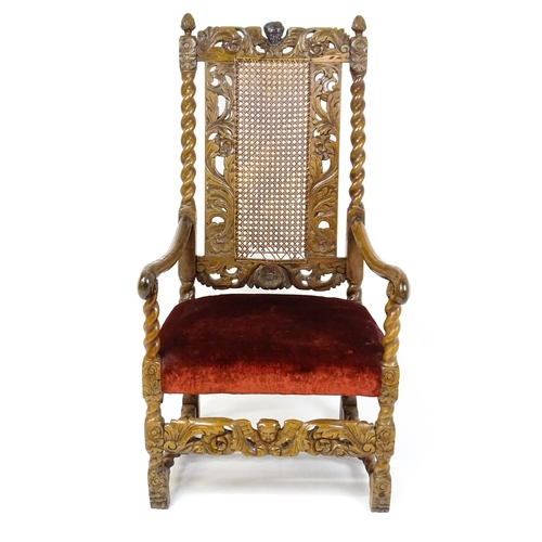 1793 - A 19thC Carloean style armchair with a carved cresting rail above barley twist supports and a caned ... 