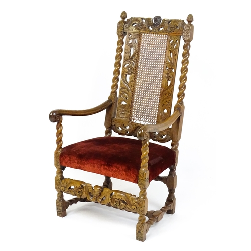 1793 - A 19thC Carloean style armchair with a carved cresting rail above barley twist supports and a caned ... 