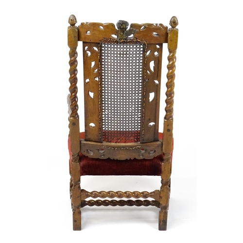 1793 - A 19thC Carloean style armchair with a carved cresting rail above barley twist supports and a caned ... 