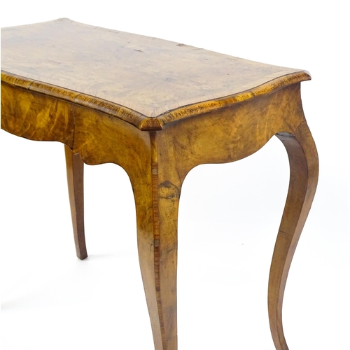 1800 - A late 19thC Louis XV style walnut side table with a shaped, moulded top above a single frieze drawe... 