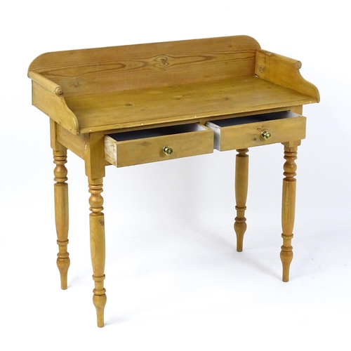 1801 - A Victorian pine washstand with a raised upstand above two short frieze drawers raised on four turne... 