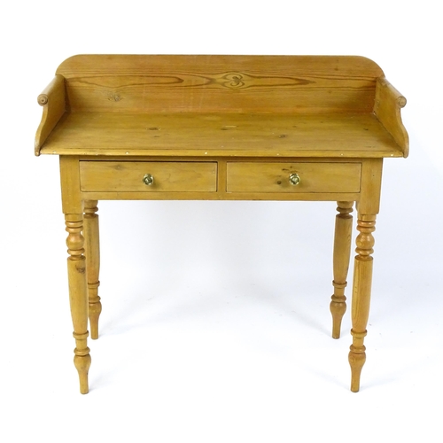 1801 - A Victorian pine washstand with a raised upstand above two short frieze drawers raised on four turne... 