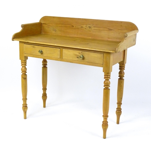 1801 - A Victorian pine washstand with a raised upstand above two short frieze drawers raised on four turne... 