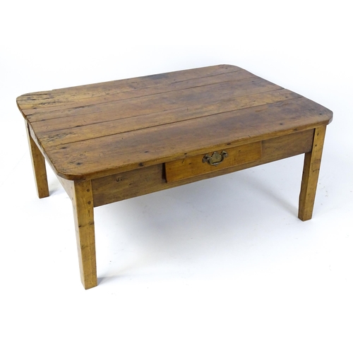 1805 - A 19thC fruitwood coffee table with a single frieze drawer, a peg jointed frame and raised on four t... 