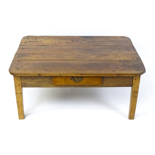 1805 - A 19thC fruitwood coffee table with a single frieze drawer, a peg jointed frame and raised on four t... 