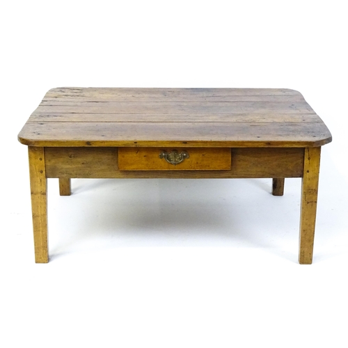 1805 - A 19thC fruitwood coffee table with a single frieze drawer, a peg jointed frame and raised on four t... 