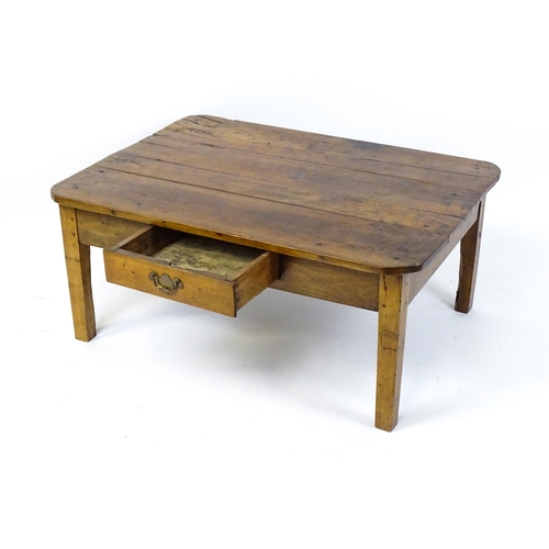 1805 - A 19thC fruitwood coffee table with a single frieze drawer, a peg jointed frame and raised on four t... 