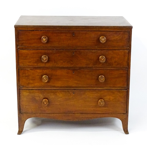 1806 - An early / mid 19thC mahogany chest of drawers with a reeded top above four long drawers with turned... 