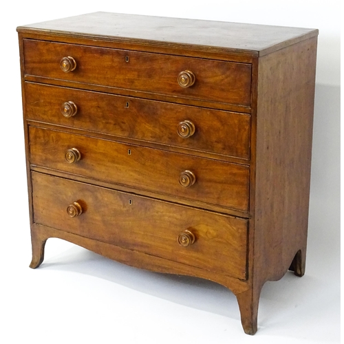 1806 - An early / mid 19thC mahogany chest of drawers with a reeded top above four long drawers with turned... 