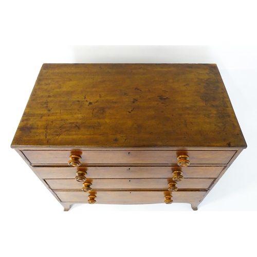 1806 - An early / mid 19thC mahogany chest of drawers with a reeded top above four long drawers with turned... 