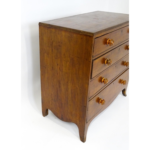 1806 - An early / mid 19thC mahogany chest of drawers with a reeded top above four long drawers with turned... 