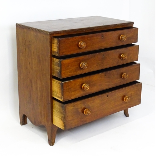 1806 - An early / mid 19thC mahogany chest of drawers with a reeded top above four long drawers with turned... 