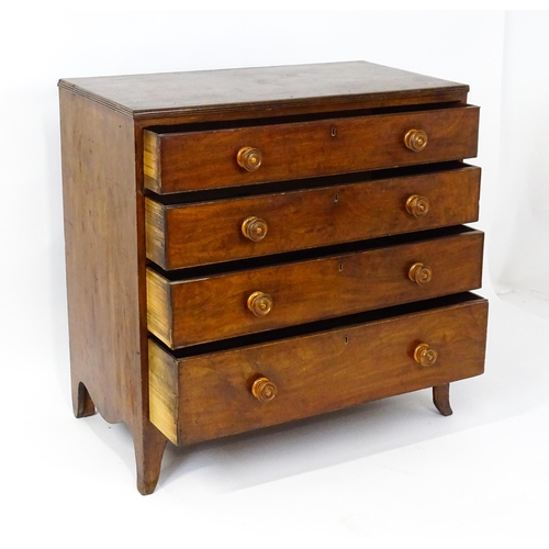 1806 - An early / mid 19thC mahogany chest of drawers with a reeded top above four long drawers with turned... 