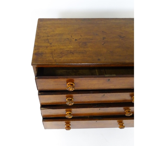 1806 - An early / mid 19thC mahogany chest of drawers with a reeded top above four long drawers with turned... 