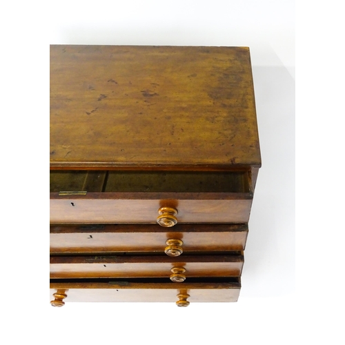 1806 - An early / mid 19thC mahogany chest of drawers with a reeded top above four long drawers with turned... 