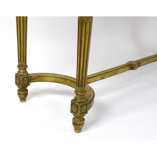 1808 - A 19thC gilt stool with a caned seat raised on four turned tapering legs with fluted decoration and ... 