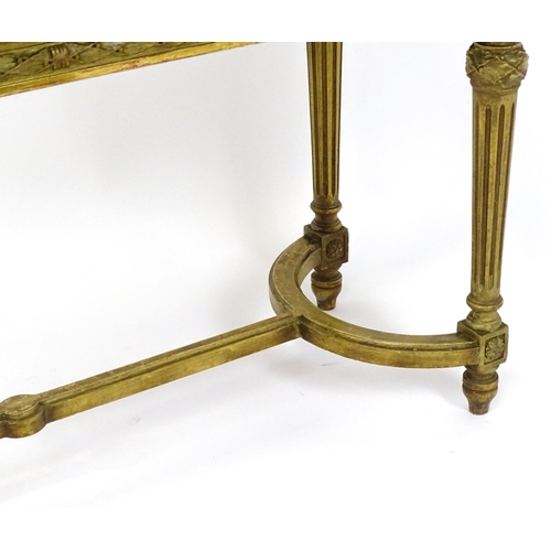 1808 - A 19thC gilt stool with a caned seat raised on four turned tapering legs with fluted decoration and ... 