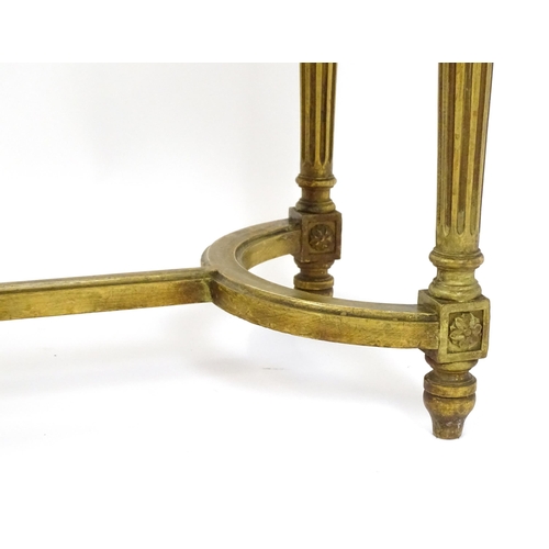 1808 - A 19thC gilt stool with a caned seat raised on four turned tapering legs with fluted decoration and ... 