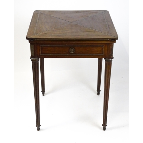 1809 - A 19thC mahogany envelope card table with two frieze drawers raised on four turned tapering and reed... 