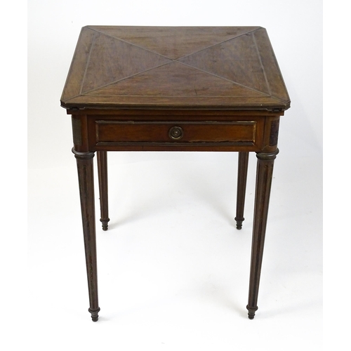 1809 - A 19thC mahogany envelope card table with two frieze drawers raised on four turned tapering and reed... 